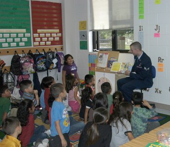 Senior Airman Mark Gabenski reads to children at Gallardo Elementary Nov. 11, 2008. Approximately 30 Team Lackland Airmen spent part of the Veterans Day holiday with the children, reading to them and answering any questions they had about the Air Force. More than 300 students in kindergarten through fifth grade participated in the event. Airman Gabenski is with the 37th Mission Support Squadron at Lackland Air Force Base, Texas. (USAF photo by Bill Gaines)                                    