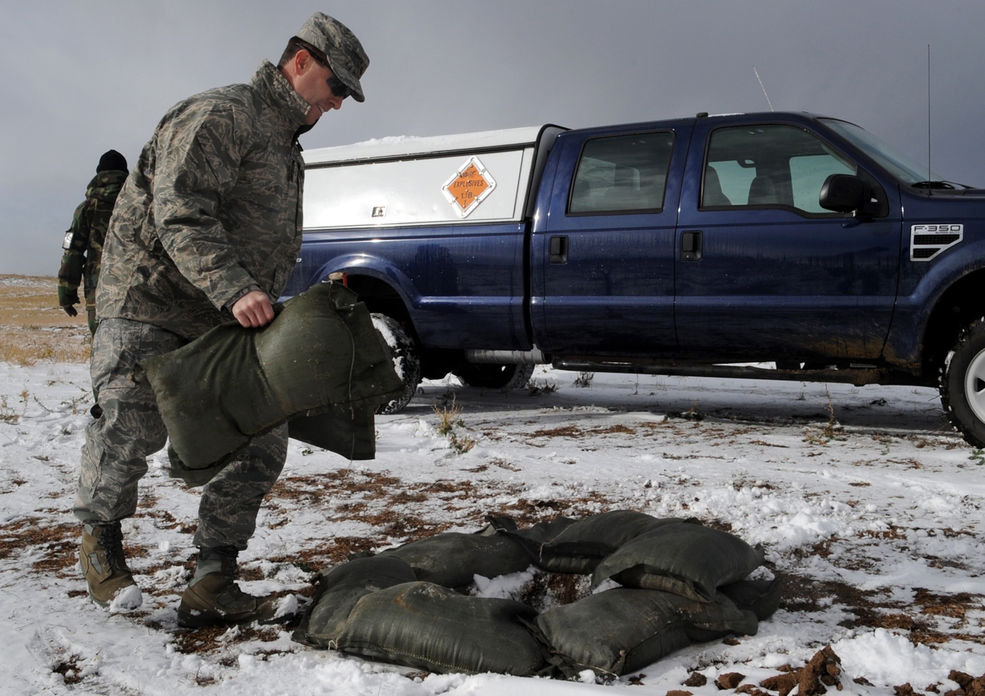 BUCKLEY AIR FORCE BASE, Colo. -- Major Gordon Hunter of the 8th Civil Support Team helps construct a barrier here, Nov. 14, to control an explosion of dynamite after it was determined to be unstable. (U.S. Air Force photo by Senior Airman Steve Czyz)
