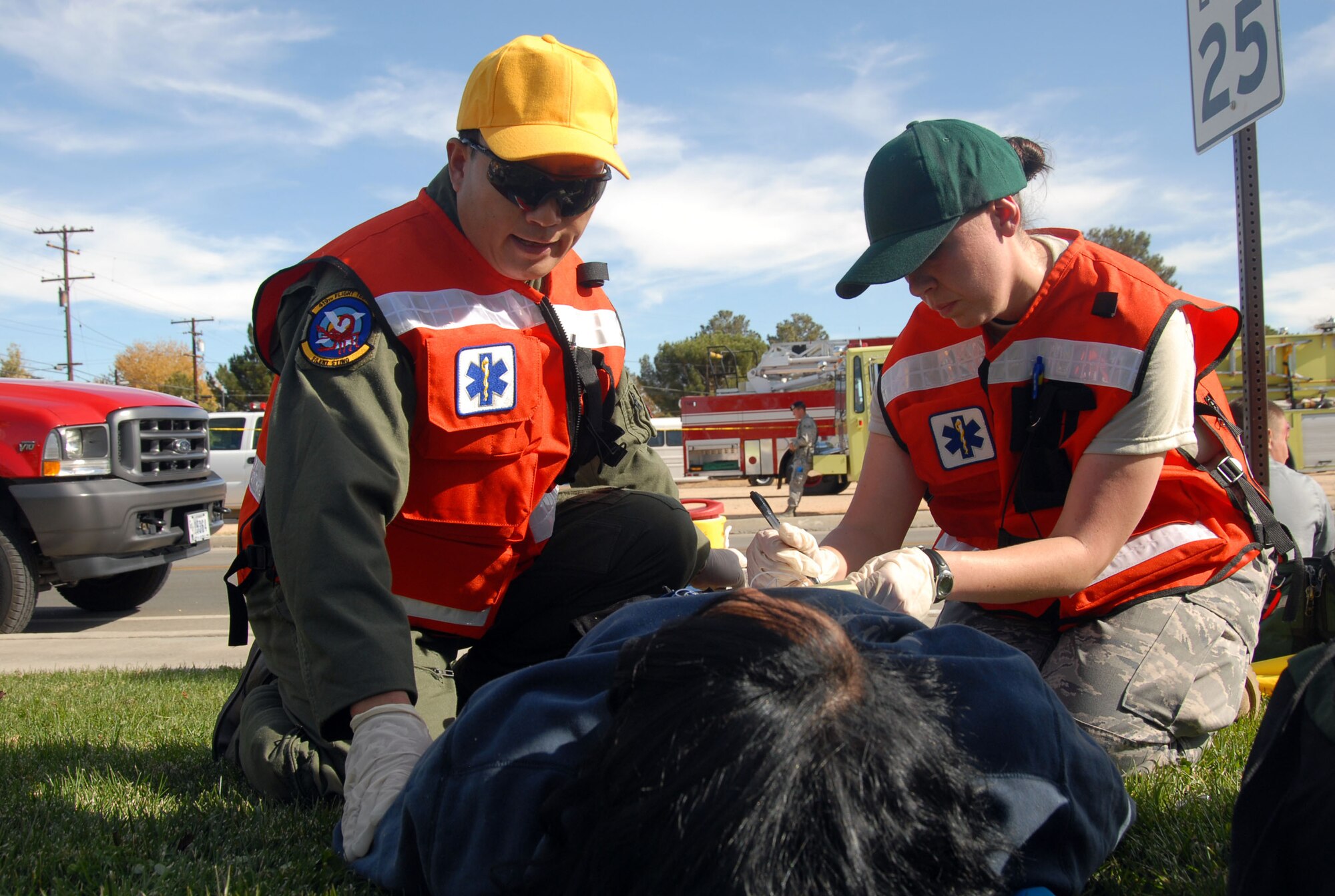 Lt. Col. Jianzhong Zhang, 95th Aerospace Medicine Squadron flight surgeon, talks to an earthquake victim while Staff Sgt. Jessica Reese, 95th Medical Group aerospace medical technician, writes the information as part of the Great Southern California Shakeout exercise Nov. 14. (Air Force photo Senior Airman Julius Delos Reyes)