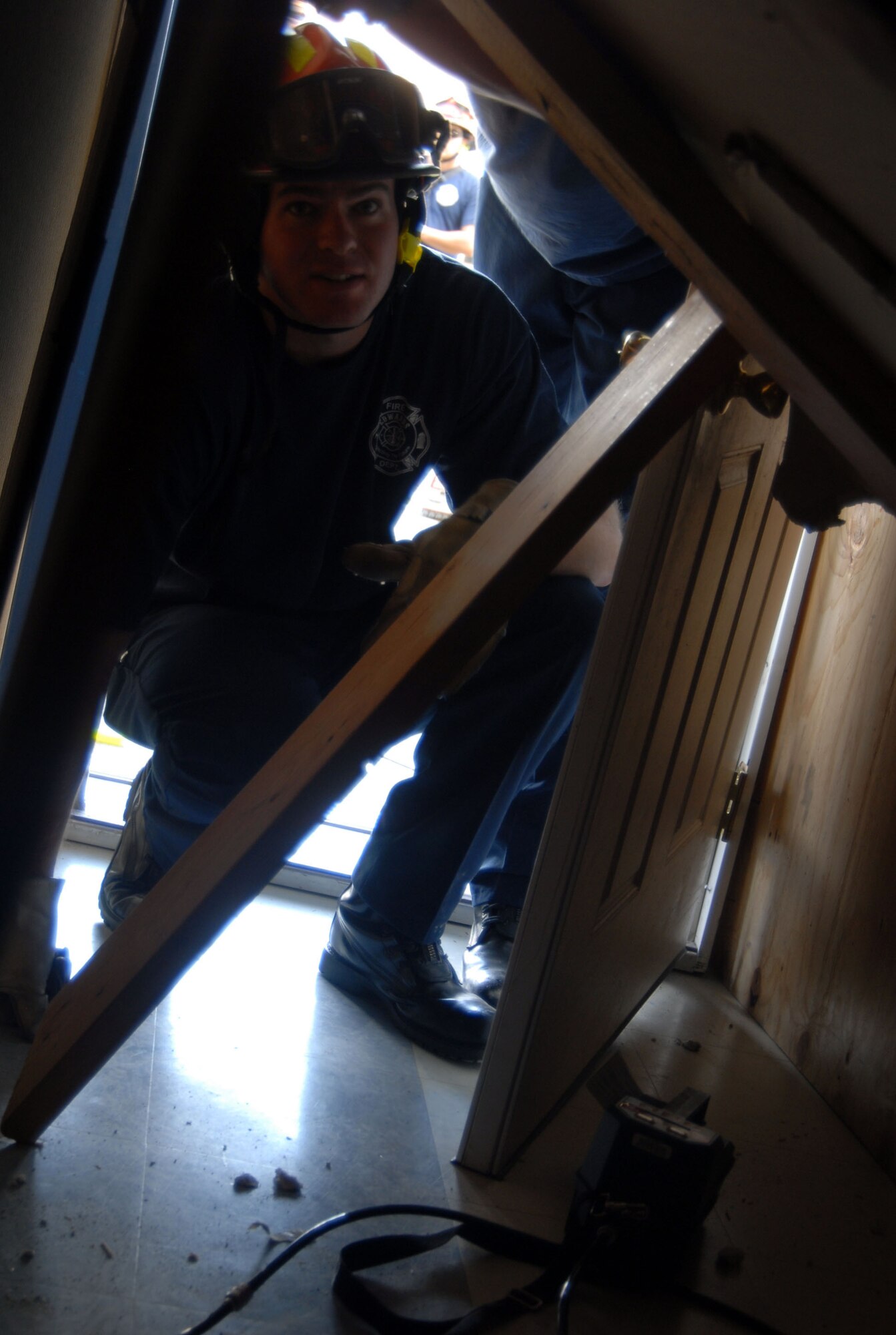 An Edwards firefighter inspects the damaged on a school building caused by a simulated magnitude 7.8 earthquake Nov. 13 as part of the Great Southern California Shakeout. The exercise tested California's and the base's capability to respond and recover from a major earthquake. (Air Force photo by Senior Airman Julius Delos Reyes)