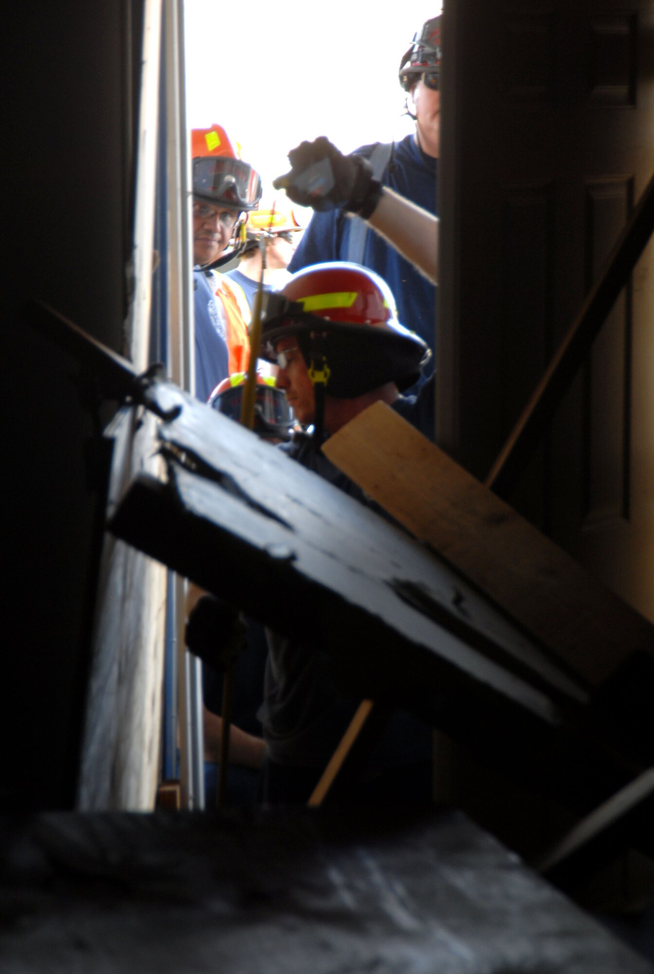 Edwards firefighters measure the door of a school building to evacuate trapped victims of a simulated magnitude 7.8 earthquake that shook Southern California and Edwards on Nov. 13. This was part of the Great Southern California Shakeout Exercise, the largest earthquake disaster exercise in the U.S. history. (Air Force photo by Senior Airman Julius Delos Reyes)