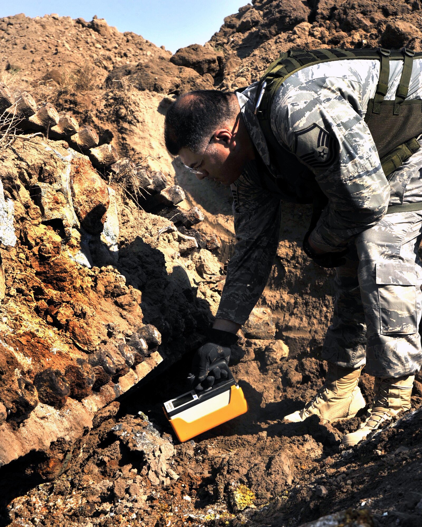 Master Sgt. Daniel Torres double-checks for any hint of radiation hazards around an old Iraqi T-72 Main Battle Tank that was found burried on the airfield at Sather Air Base, Iraq. The tank was an obstruction to safe airfield operations and had to be removed. Sergeant Torres is assigned to the from the 447th Expeditionary Civil Engineer Squadron Emergency Management Flight. (U.S. Air Force photo/Master Sgt. Brian Davidson)

