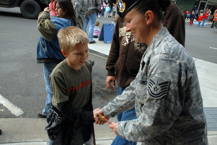 Tech. Sgt. Lisa Hodgden, 9th Security Forces Squadron, shakes hands with Cesar Garcia, age 9, at the Marysville Veterans Day parade Nov. 11. (Photo by Staff Sgt. Sarah Gregory)