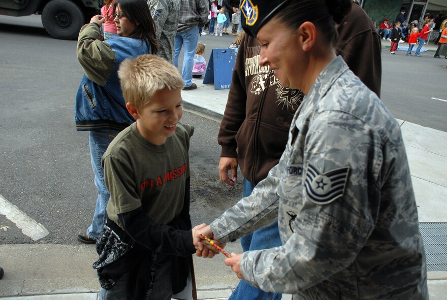 Tech. Sgt. Lisa Hodgden, 9th Security Forces Squadron, shakes hands with Cesar Garcia, age 9, at the Marysville Veterans Day parade Nov. 11. (Photo by Staff Sgt. Sarah Gregory)