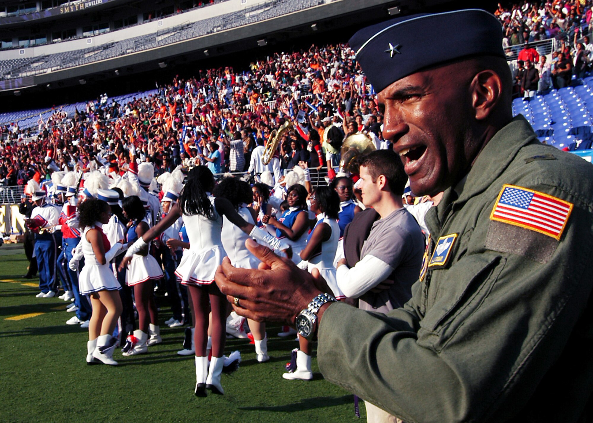 Brig. Gen. Alfred J. Stewart cheers the Baltimore Polytechnic Institute High School football team following its 16-13 win over Baltimore City College High School Nov. 8 at M&T Bank Stadium in Baltimore. A Class of 1977 Baltimore Polytechnic Institute High School alumni, General Stewart shared inspirational words with both teams before the game and he presented a $500 college scholarship to a member of both high schools. General Stewart is the Air Force Recruiting Service commander. (U.S. Air Force photo/Tech. Sgt. Jennifer Lindsey) 
