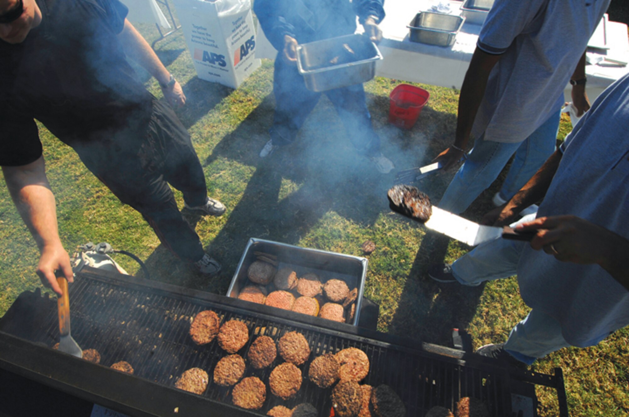 The grillmasters braved the smokey elements while preparing food for the 3,500 plus Airmen who attended the base Wingman Day picnic.