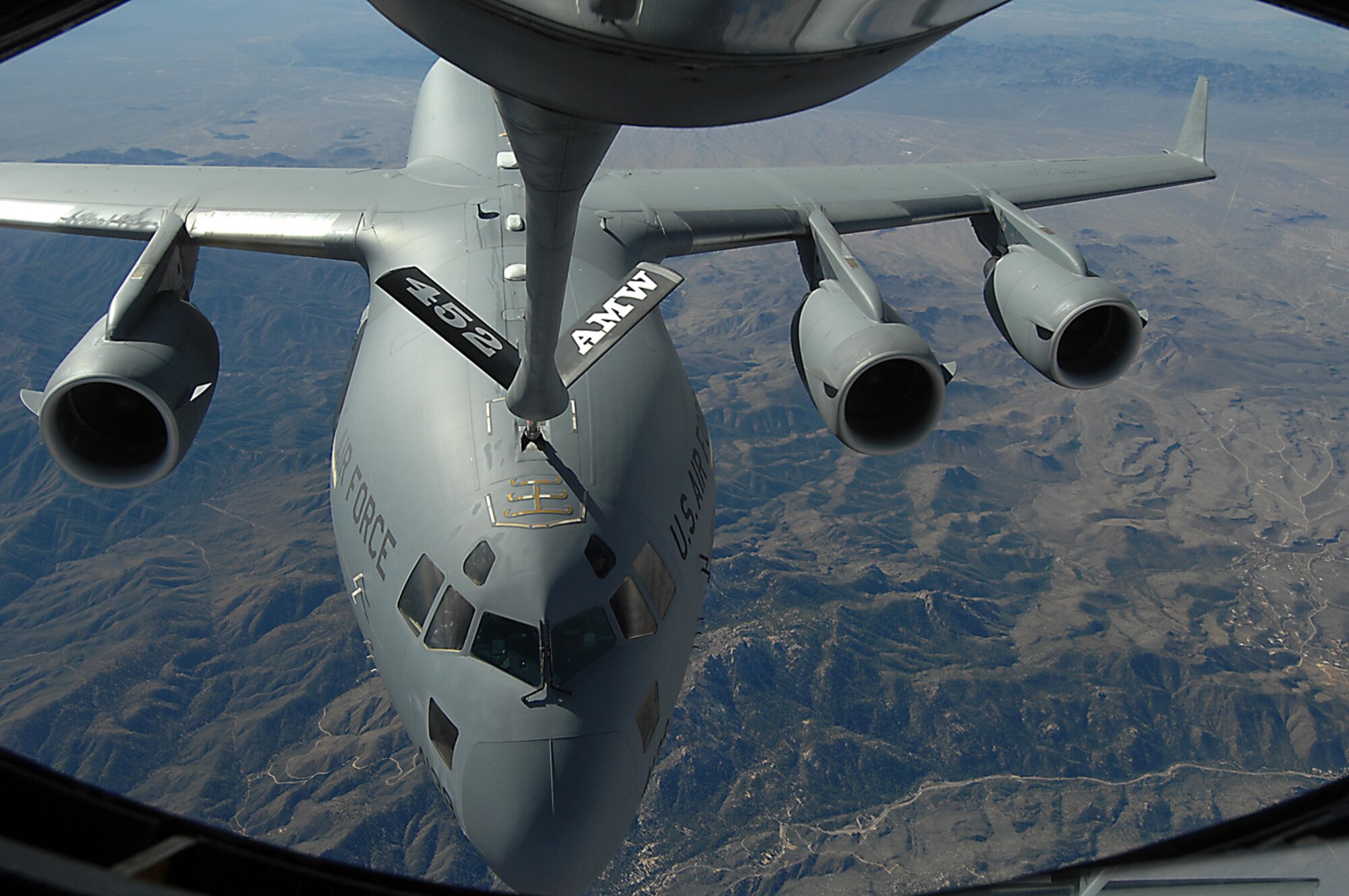 A C-17A Globemaster III receives fuel from a KC-135R Stratotanker during an aerial refueling mission over the Southwest United States, Nov. 12. Both aircraft are from the 452nd Air Mobility Command at March Air Reserve Base and are taking part in a Media Flight for Los Angeles Air Force Week. (Photo by Master Sgt Rick Sforza)

