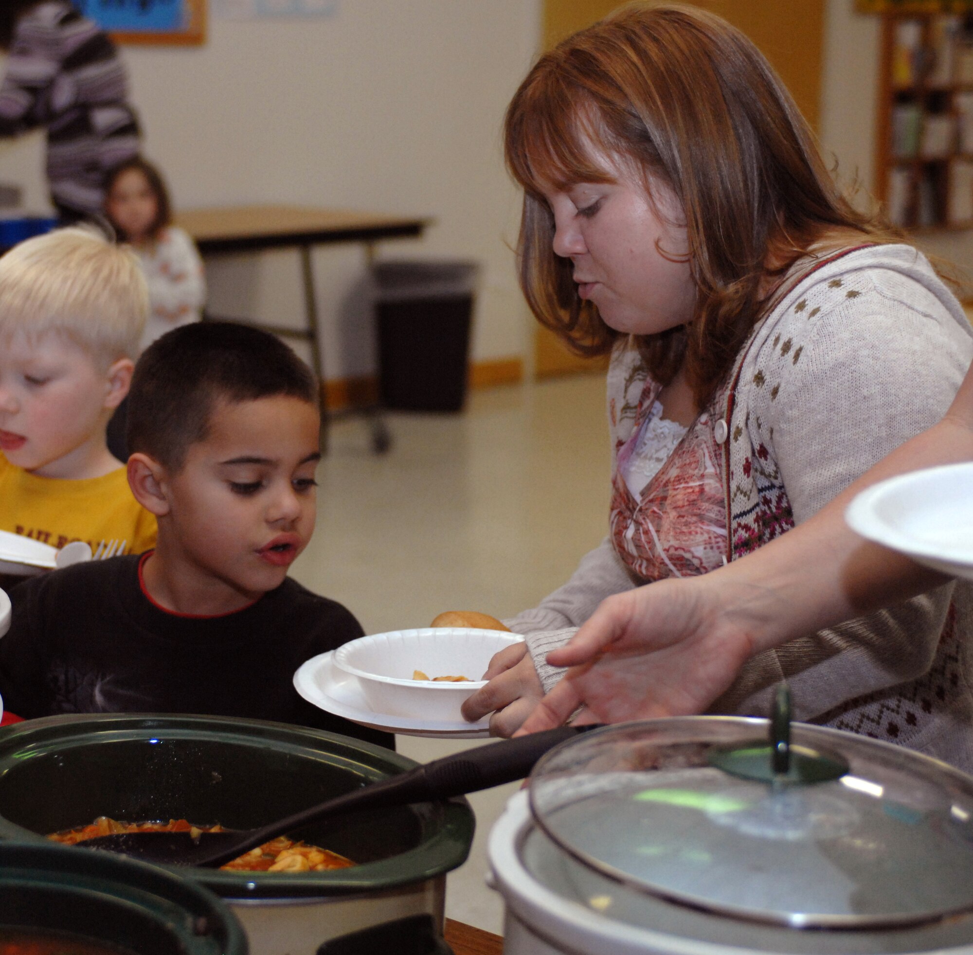 Yvonne Gaston and her son, Nathan, serve themselves soup during the Families Apart Dinner at the Chapel and Holloman Air Force Base, N.M., Nov. 12. The Airman and Family Readiness Center holds a Families Apart Dinner at least every quarter for spouses and children of deployed members to get together and enjoy a dinner and crafts. This meal was sponsored by Holloman?s Key Spouses. The 49th Force Support Squadron will be hosting another Families Support Dinner Dec. 17 in conjunction with the ?Deployed Expo?. For more information, contact the Airman and Family Readiness Center at 572-7754. (U.S. Air Force photo/Airman Sondra M. Escutia)