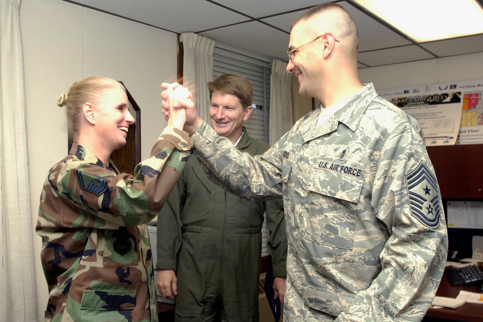 FAIRCHILD AIR FORCE BASE, Wash. – Chief Master Sgt. David Nordel, 92nd Air Refueling Wing command chief, congratulates Senior Master Sgt. Julie Layton, 92nd ARW, on her selection for promotion to chief, Nov. 12. Three of Fairchild’s senior master sergeants were selected. (U.S. Air Force photo / Senior Airman Eunique Stevens)