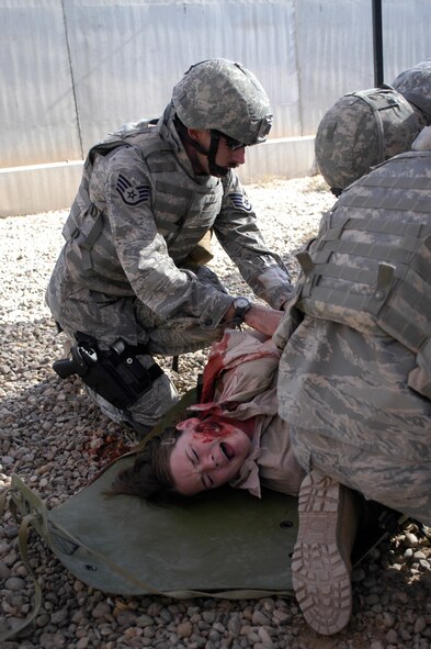 Staff Sgt. Rodney Franken, 532nd Expeditionary Security Forces Squadron, coordinates treatment for a roleplayer who was simulated wounded for training at Joint Base Balad, Iraq, Nov. 12. Sergeant Franken, a security forces journeyman deployed from the 435th Security Forces Squadron, at Ramstien Air Force Base, Germany, attended combat lifesaver training which is a requirement for personnel in the 332nd Expeditionary Security Forces Group. (U.S. Air Force photo/Tech. Sgt. Craig Lifton) 