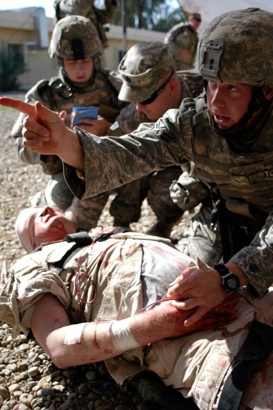 Airman 1st Class Ryan Allen, 532nd Expeditionary Security Forces Squadron, coordinates treatment for a roleplayer who was simulated wounded for training at Joint Base Balad, Iraq, Nov. 12. Airman Allen, a security forces apprentice deployed from the 99th Security Forces Squadron, at Nellis Air Force Base, Nev., attended combat lifesaver training, which is a requirement for personnel in the 332nd Expeditionary Security Forces Group. He is a native of Colorado Springs, Colo. (U.S. Air Force photo/Tech. Sgt. Craig Lifton) 