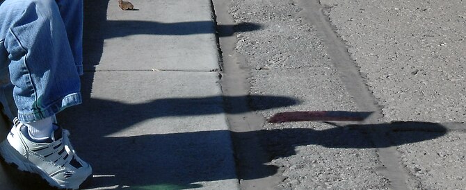 A young child sits on the corner of 10th Street waving an American flag as military members of Otero County pass out candy during the Veterans Day parade, Nov. 8,  in Alamogordo, N.M.The Veterans Day National Ceremony is held Nov.11 each year at Arlington National Cemetery. A color guard made up of members from each of the military services, renders honors to America's war dead during a tradition-rich ceremony at the Tomb of the Unkowns.(U.S. Air Force photo/ Senior Airman Anthony Nelson)
