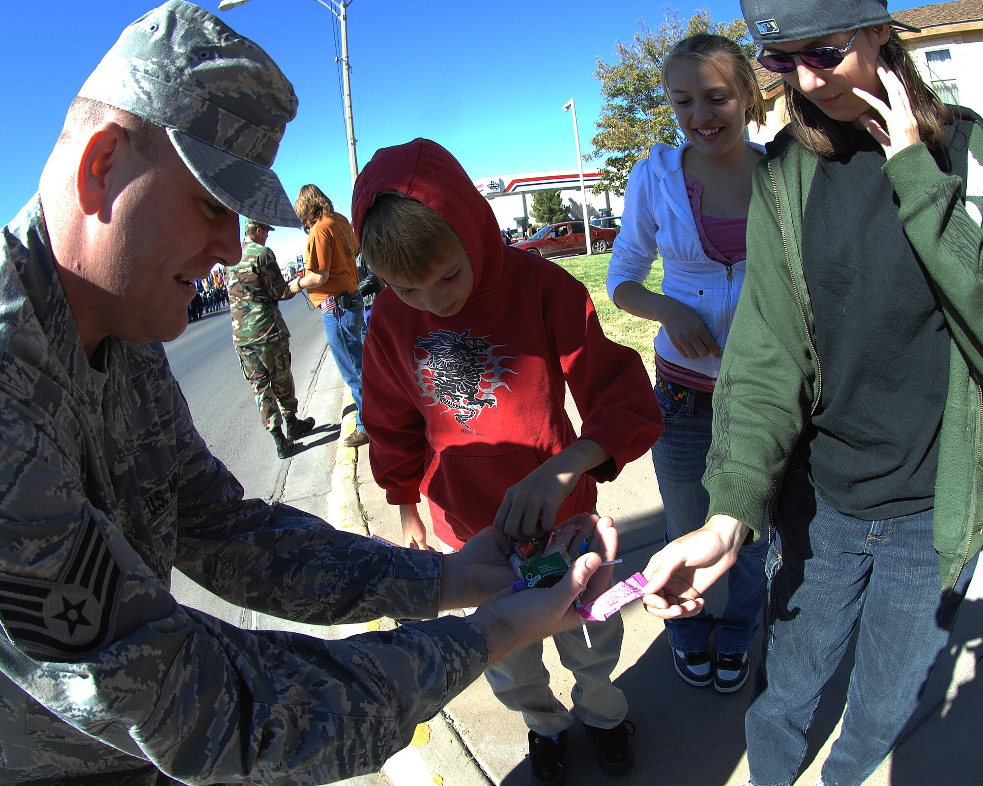 Amember of Holloman Air Force Base, N.M., passes out candy to children during the Veterans Day parade Nov. 8, in Alamogordo, N.M. The Veterans Day National Ceremony is Nov. 11 each year at Arlington National Cemetery.

(U.S. Air Force photo/ Senior Airman Anthony Nelson)
