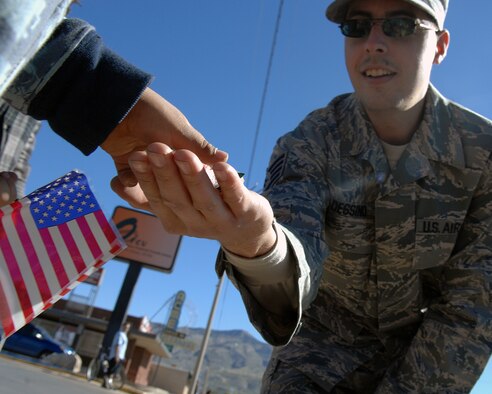 Amember of Holloman Air Force Base, N.M., passes out candy to children during the Veterans Day parade Nov. 8, in Alamogordo, N.M. The Veterans Day National Ceremony is Nov. 11 each year at Arlington National Cemetery.(U.S. Air Force photo/ Senior Airman Anthony Nelson)
