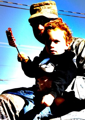 Team Holloman members escort children during the Veterans Day parade, Nov. 8, Alamogordo, N.M.The Veterans Day National Ceremony is held Nov. 11 each year at Arlington National Cemetery. A color guard made up of members from each of the military services, renders honors to America's war dead during a tradition-rich ceremony at the Tomb of the Unkowns.(U.S. Air Force photo/ Senior Airman Anthony Nelson)