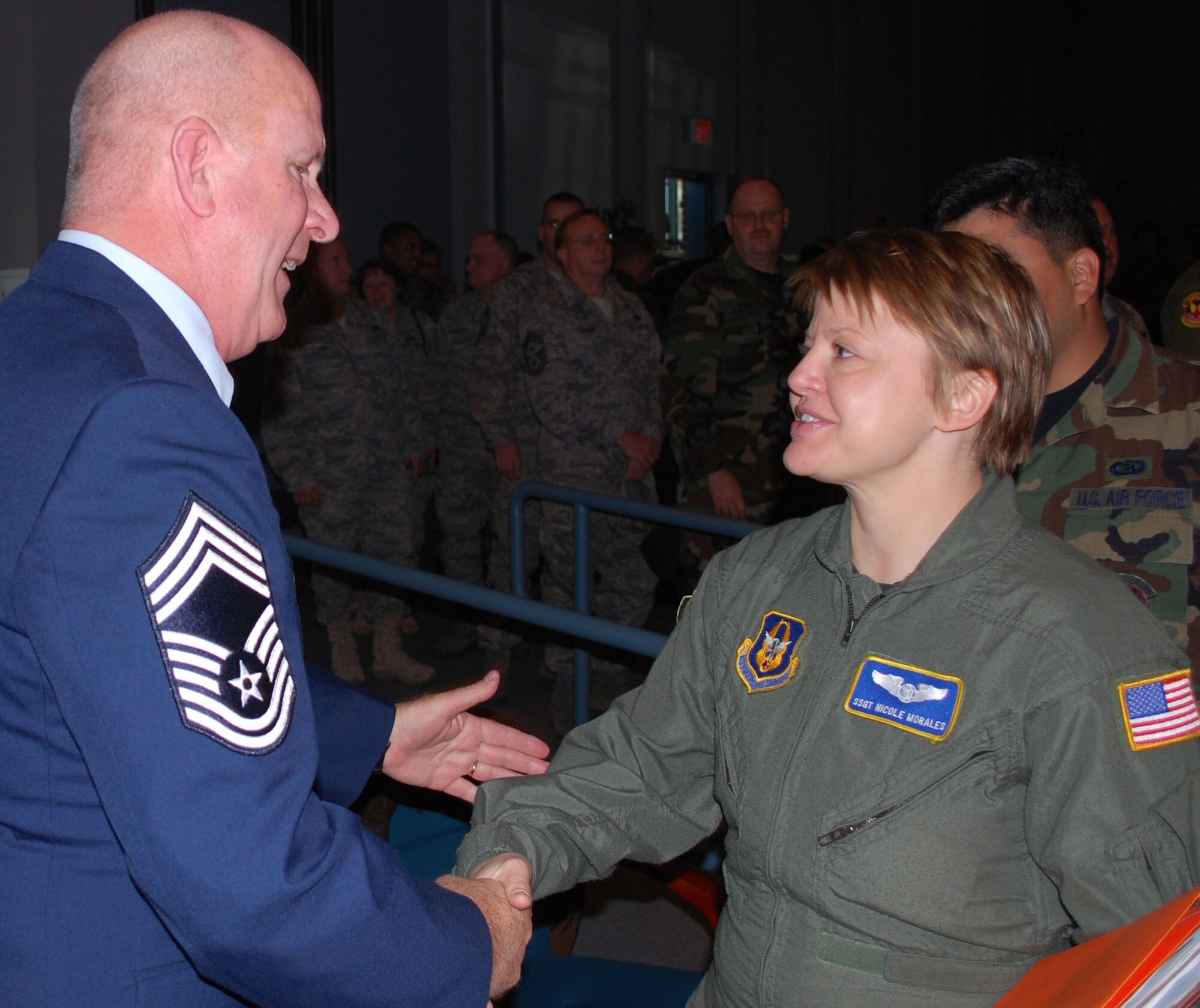 Staff Sgt. Nicole Morales, 439th Aeromedical Evacuation Squadron, is among scores of Patriot Wing reservists shaking hands with retiring Chief Master Sgt. Jeffrey Sherwin, following his ceremony Nov. 2. Chief Sherwin, assigned to AES, and a former wing command chief and Army tank gunner who saw combat duty in Vietnam, capped his 32-year career with the retirement ceremony held at the Westover Conference Center. (US Air Force photo/ Tech. Sgt. Andrew Biscoe)