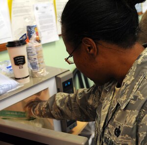 LANGELY AIR FORCE BASE, Va. -- Tech. Sgt. Andrea Smith, 735th Supply Chain Management Group supply craftsman, pulls her omelet out of the microwave after making sure it was cooked thoroughly Nov. 13. The "How To Make a Meal using only a Microwave Bag" class showed participants how to make something healthy in a quick and easy manner. (U.S. Air Force photo/Airman 1st Class Zachary Wolf)