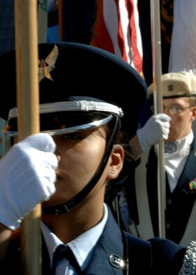 Airman 1st Class Stephanie Lenard, Holloman Air Force Base, N.M., Steel Talons Honor Guard member, along side Alamogordo High School Junior Reserve Officers' Training Corps (ROTC) particapate in the Veterans Day parade, Nov. 8, in Alamogordo, N.M. The duties of the Steel Talons are primarily performing military funerals. The Talons also perform Colors and other details at other military ceremonies. (U.S. Air Force photo/ Senior Airman Anthony Nelson)