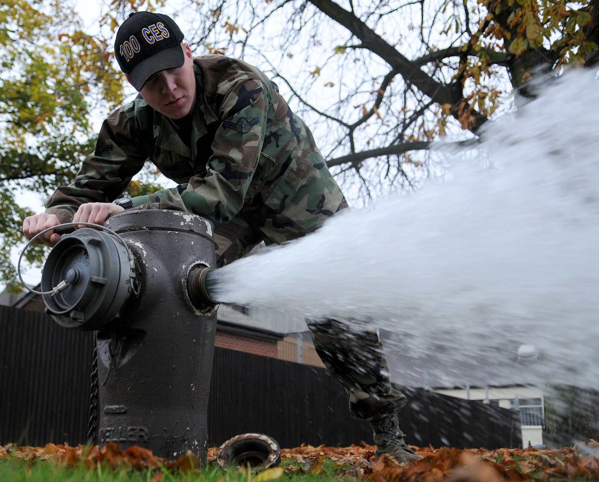 Airman James Hanna, a 100th Civil Engineer Squadron utilities system operator apprentice, flushes a fire hydrant to clear the water line Nov. 3, 2008, at RAF Mildenhall, England. Airman Hanna performs the flush to ensure proper water pressure and flow. This check is done annually to all fire hydrants to establish serviceability. (U.S. Air Force photo by Staff Sgt. Jerry Fleshman)