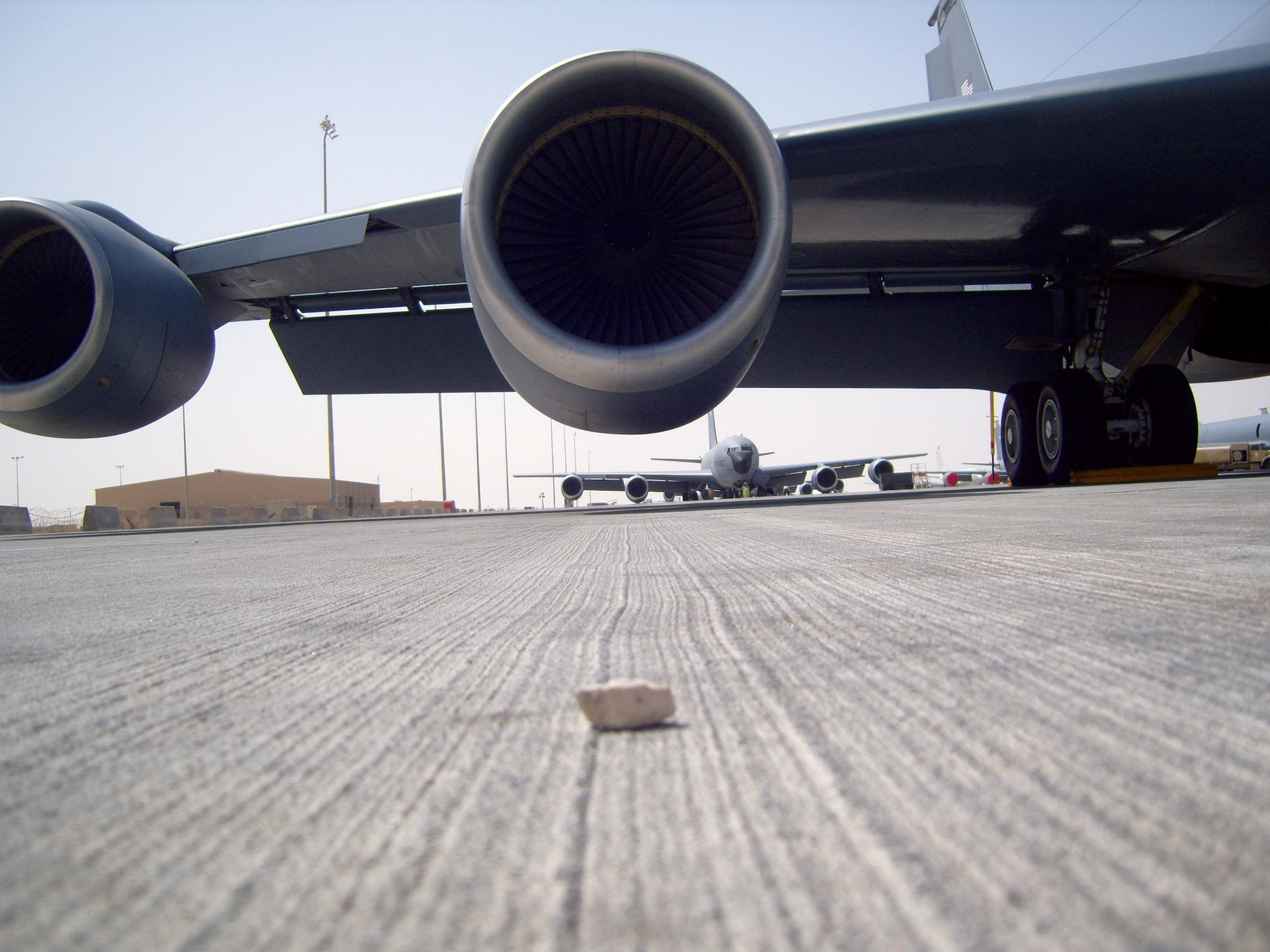 A rock sits on the flightline near an aircraft on a base at an undisclosed location in Southwest Asia. Rocks and other foreign object debris cause millions of dollars in aircraft damage each year. To deal with the problem the 379th Air Expeditionary Wing has an active FOD prevention program. (Courtesy photo)