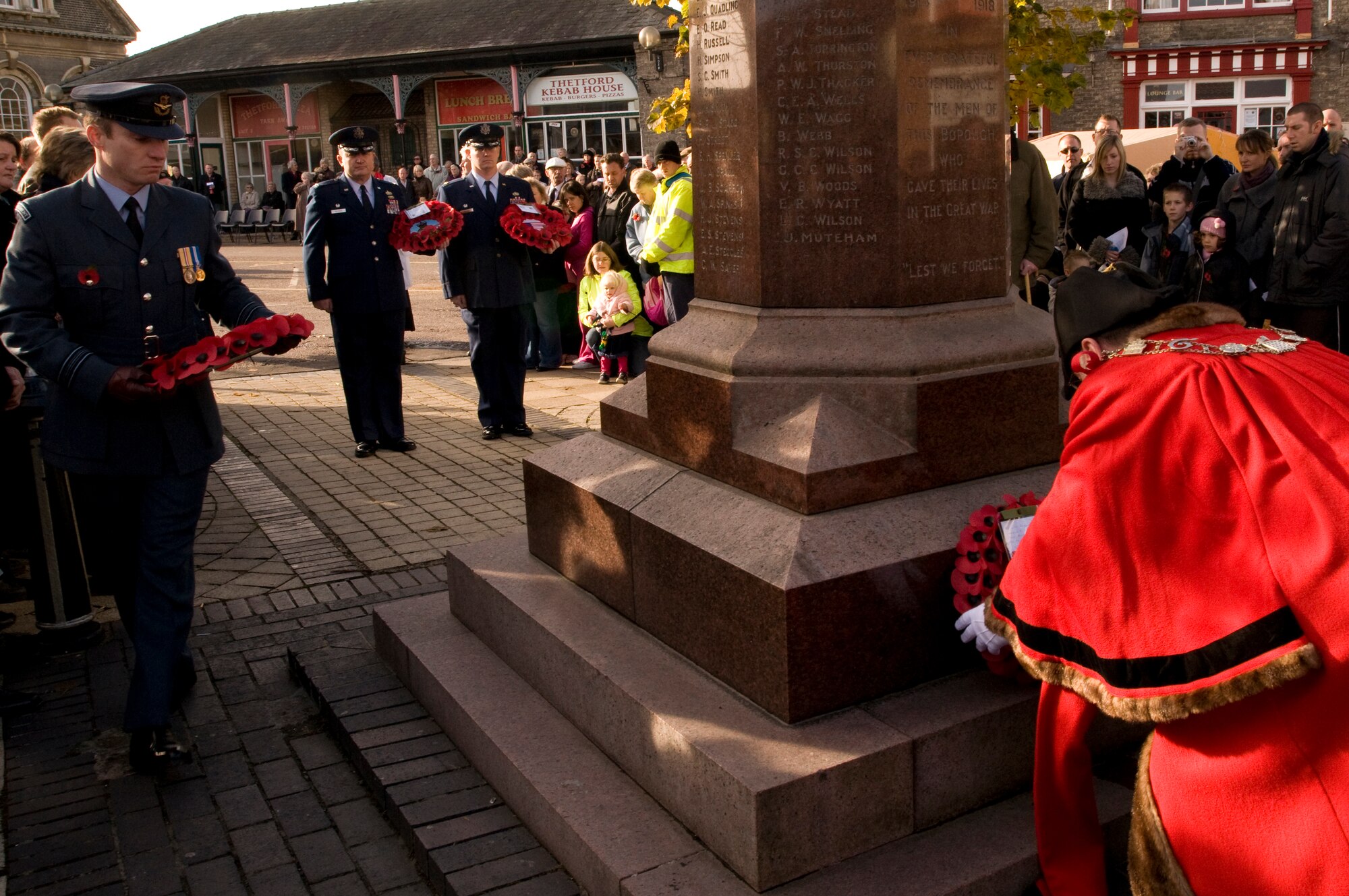 Colonel Jeffrey Bateman, 100th Mission Support Group commander, waits with his fellow Airmen for their opportunity to lay a wreath of remembrance at the foot of a war memorial in Thetford, England. Airmen from RAF Lakenheath participated in Remembrance Day ceremonies by honoring those who fought by laying wreaths throughout East Anglia. (U.S. Air Force photo by Staff Sgt. Nathan Gallahan)