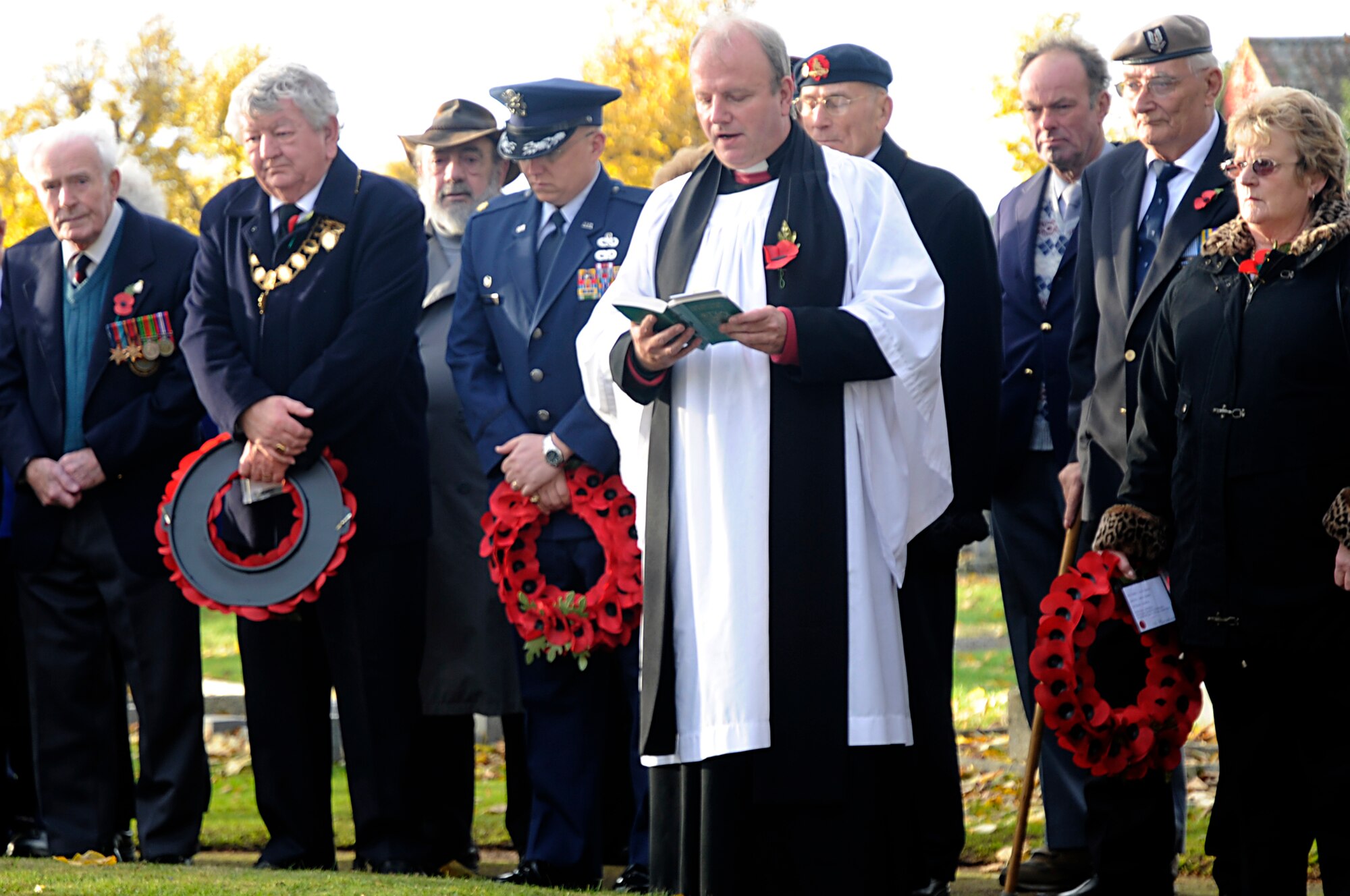 Major Darrin Dronoff, 48th Equipment Maintenance Squadron commander, along with British dignitaries, bows in prayer at the WWI memorial in Brandon church yard, England, Nov 9. Airmen from RAF Lakenheath participated in Remembrance Day ceremonies, honoring those who fought by laying wreaths at various memorials throughout East Anglia. (U.S. Air Force photo by Staff Sgt. Felicia Welch)