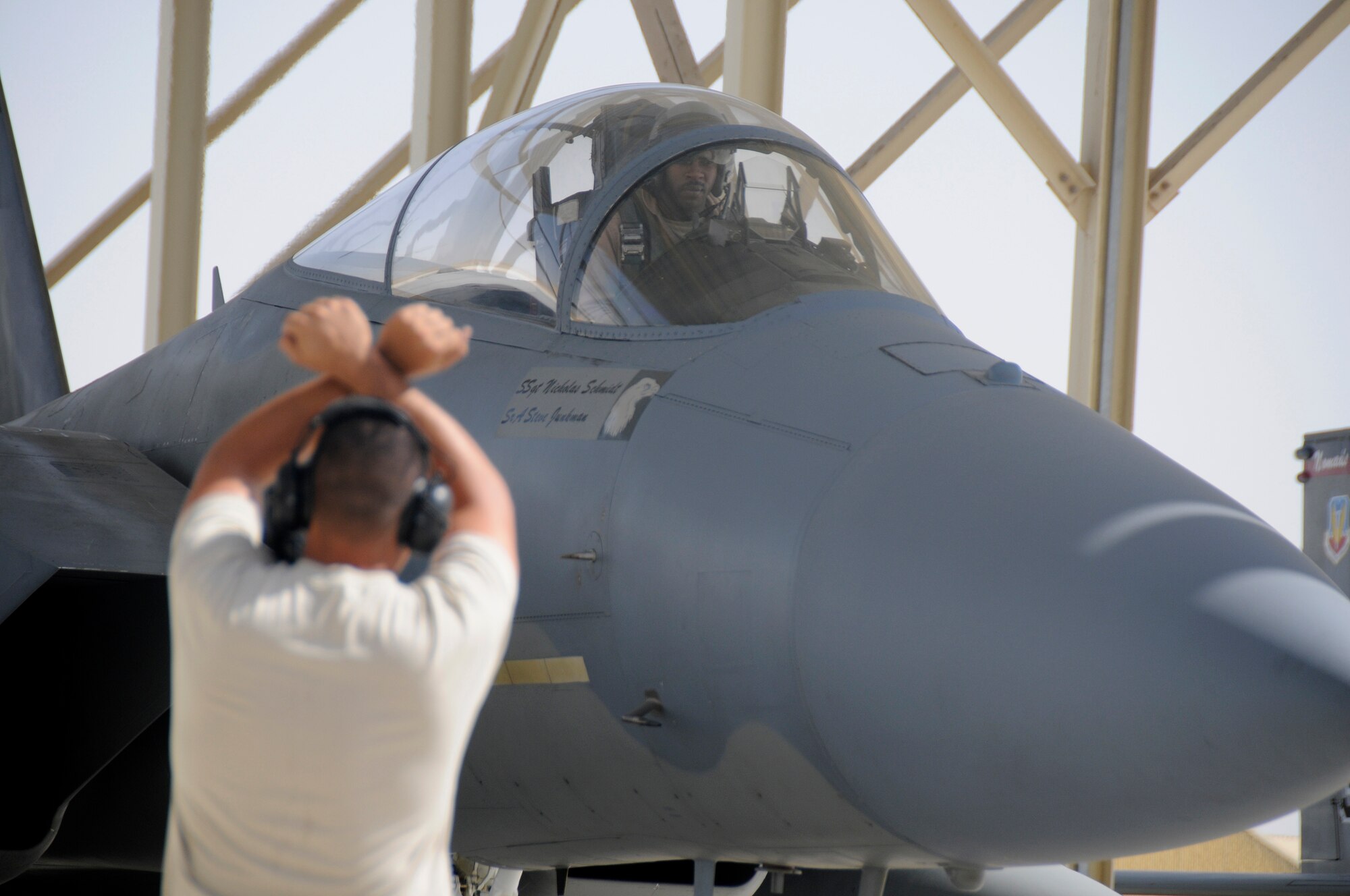 SOUTHWEST ASIA -- Capt. Rick Jones, pilot, looks to Staff Sgt. Mike Membrilla for directions to safely maneuver his F-15 Strike Eagle onto the runway here Nov. 13. Captain Jones and Sergeant Membrilla are members of the 58th Fighter Squadron, Eglin Air Force Base, Fla. They are deployed here in support of a multinational exercise. The exercise is held to provide coalition training with various airframes, improving interoperability while honing skills. The exercise is held throughout November. (U.S. Air Force photo/Tech. Sgt. Christopher A. Campbell)(released)
