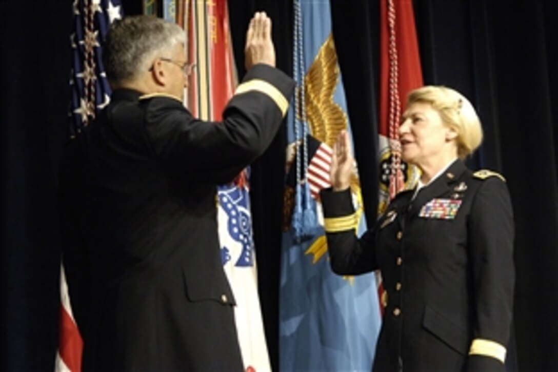 Chief of Staff of the Army Gen. George W. Casey, left, administers the oath of office to Army Gen. Ann E. Dunwoody during her promotion ceremony at the Pentagon, Nov. 14, 2008.