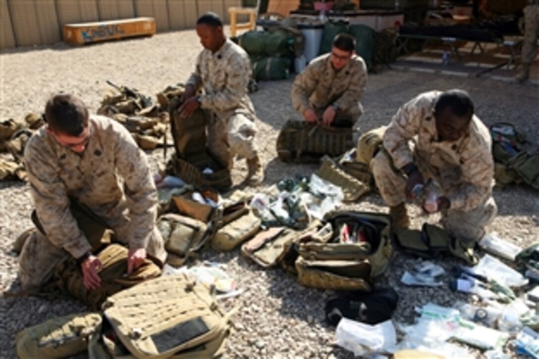 Hospital corpsmen assigned to Lima Company, 3rd Battalion, 8th Marines, prepare their field medical bags at Camp Barber, Afghanistan, Nov. 10, 2080. 