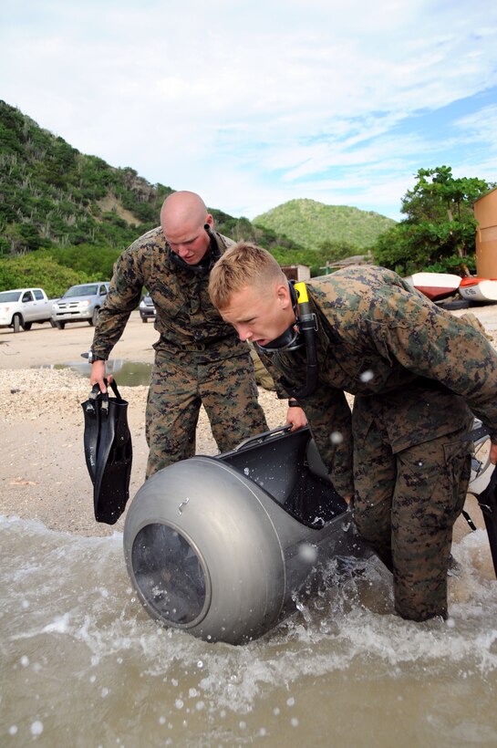 Sgt. Josh Gehert and Sgt. Michael A. Bedsun, both Team members with 2nd Force Reconnaissance Company, 2nd Reconnaissance Battalion, II Marine Expeditionary Force, carry a diver propulsion device into the ocean during DPD training in Curacao, Nov. 16.