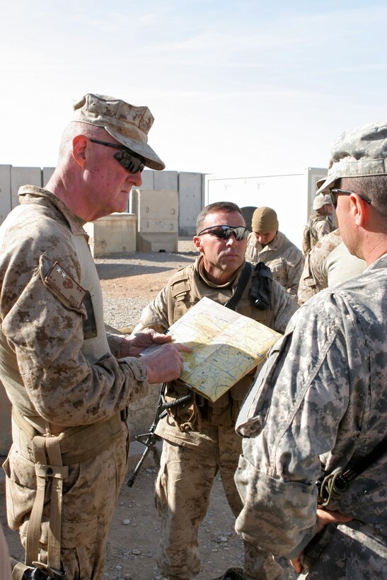 Maj. Gen. Richard P. Mills, commanding general, ground combat element, Multi National Force - West, and Col. Robert O. Sinclair, asst. chief of staff, Jump coomand post, Multi National Force - West, speak to Lt. Col. Leif W. Gunhus, commanding officer, 11th Brigade Military Transition Team, during a visit to the 11th Brigade headquarters, the Iraqi Army unit closest to the MNF-W Jump.  Mills made a visit to the Marine Air Ground Task Force in Nineweh and visited coalition forces, Iraqi forces, and tribal leaders in the area.