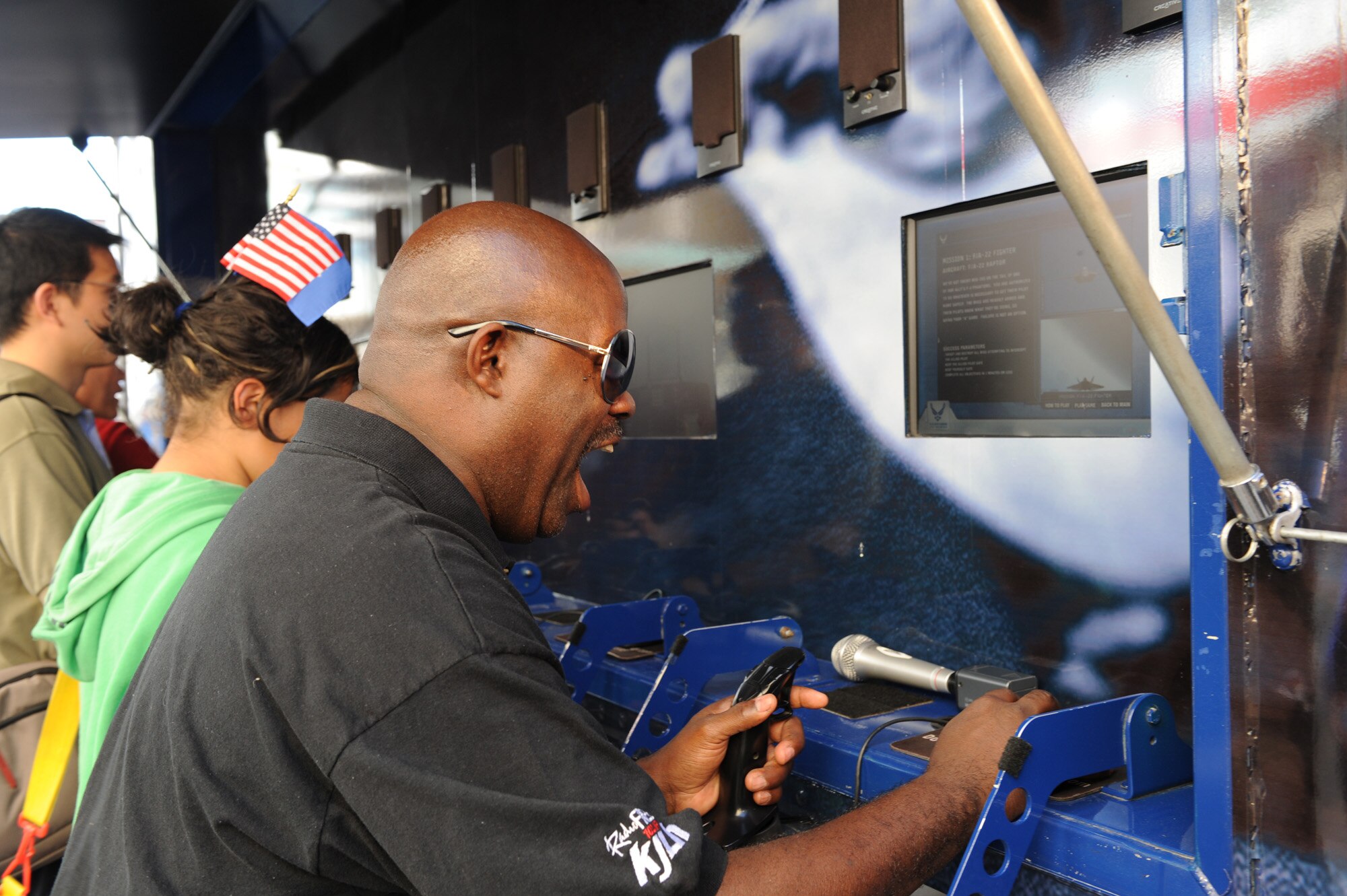 Guy Black, from "The Guy Black Show," on 102.3 FM KJLH, a Los Angeles radio station, plays a flight video game off of the U.S. Air Force's 80-foot-long tour van, “Do Something Amazing,” during the Air Force Expo at Hollywood and Highland Boulevard in Los Angeles on Nov. 14. The radio host saluted the men and women in uniform as he celebrated Air Force Week. Air Force Week Los Angeles runs until Nov. 21 and has events throughout the area.  (U.S. Air Force photo/Staff Sgt. Desiree N. Palacios)
