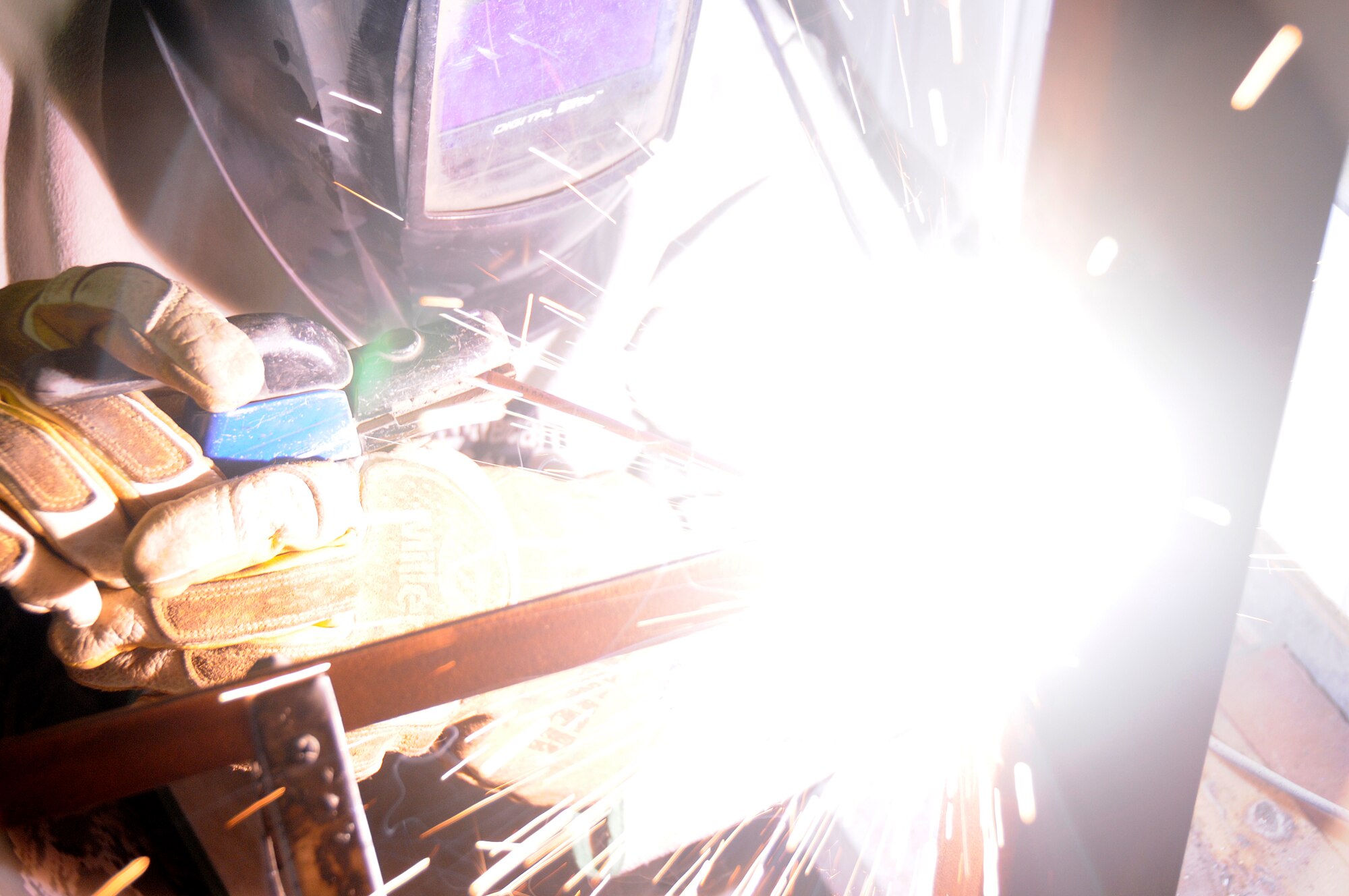 SOUTHWEST ASIA--Airman 1st Class Mack Carter from the 380th Expeditionary Civil Engineer Squadron, uses an arc welder on a brace here. He is welding a brace to a new work bench for the structures shop to increase work space and capabilities. Airman Carter is deployed from the 735th Civil Engineer Squadron, Ramstein Air Base, Germany, his hometown is Sanford, N.C.(U.S. Air Force photo/Tech. Sgt. Christopher A Campbell)(released)