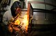 SOUTHWEST ASIA--Airman 1st Class Mack Carter from the 380th Expeditionary Civil Engineer Squadron, uses an arc welder on a brace here. He is welding a brace to a new work bench for the structures shop to increase work space and capabilities. Airman Carter is deployed from the 735th Civil Engineer Squadron, Ramstein Air Base, Germany, his hometown is Sanford, N.C.(U.S. Air Force photo/Tech. Sgt. Christopher A Campbell)(released)
