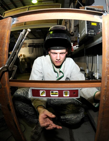 SOUTHWEST ASIA -- Airman 1st Class Mack Carter from the 380th Expeditionary Civil Engineer Squadron uses a torpedo level on a brace here. The brace will be welded onto a new work bench for the structures shop to increase work space and capabilities. Airman Carter is deployed from the 735th Civil Engineer Squadron, Ramstein Air Base, Germany, his hometown is Sanford, N.C. (U.S. Air Force photo/Tech. Sgt. Christopher A Campbell)(released)