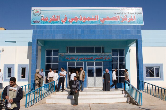 Iraqi doctors, nurses, and visitors gather outside of the Karmah Hospital, Nov. 15, 2008. Marines from Task Force 1st Battalion, 3rd Marine Regiment, Regimental Combat Team 1, were present for the grand opening of the hospital. The hospital opened its doors after years of construction and marks the first comprehensive healthcare facility in the city.