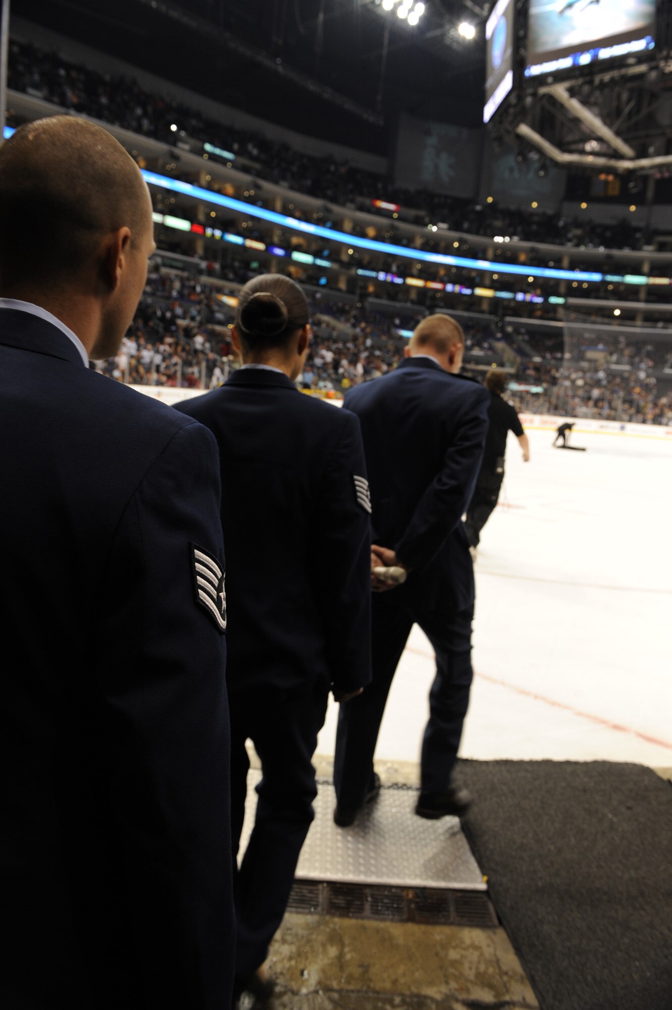 Col. John Odey leads Tech. Sgt. Surita Rorie and Staff Sgt. Robert Coddington onto the ice of the Staples Center, Los Angeles, Calif., Nov. 15. Sergeants Rorie and Coddington reenlisted during a Los Angeles Kings vs. Nashville Predator game as part of Air Force Week Los Angeles. Colonel Odey is the 95th Communications Group Commander, Edwards Air Force Base, Calif. Sergeants Rorie and Coddington are stationed at Edwards Air Force Base, Calif. Air Force Week Los Angeles is an event designed to educate the local population about the Air Force's capabilities and missions through various activities and exhibitions all over the Los Angeles area. It provides an up close and personal look at the men and women of the Air Force serving worldwide in the defense of freedom. Air Force Week Los Angeles runs from Nov. 14 to 21.  (U.S. Air Force photo/Staff Sgt. Desiree N. Palacios)