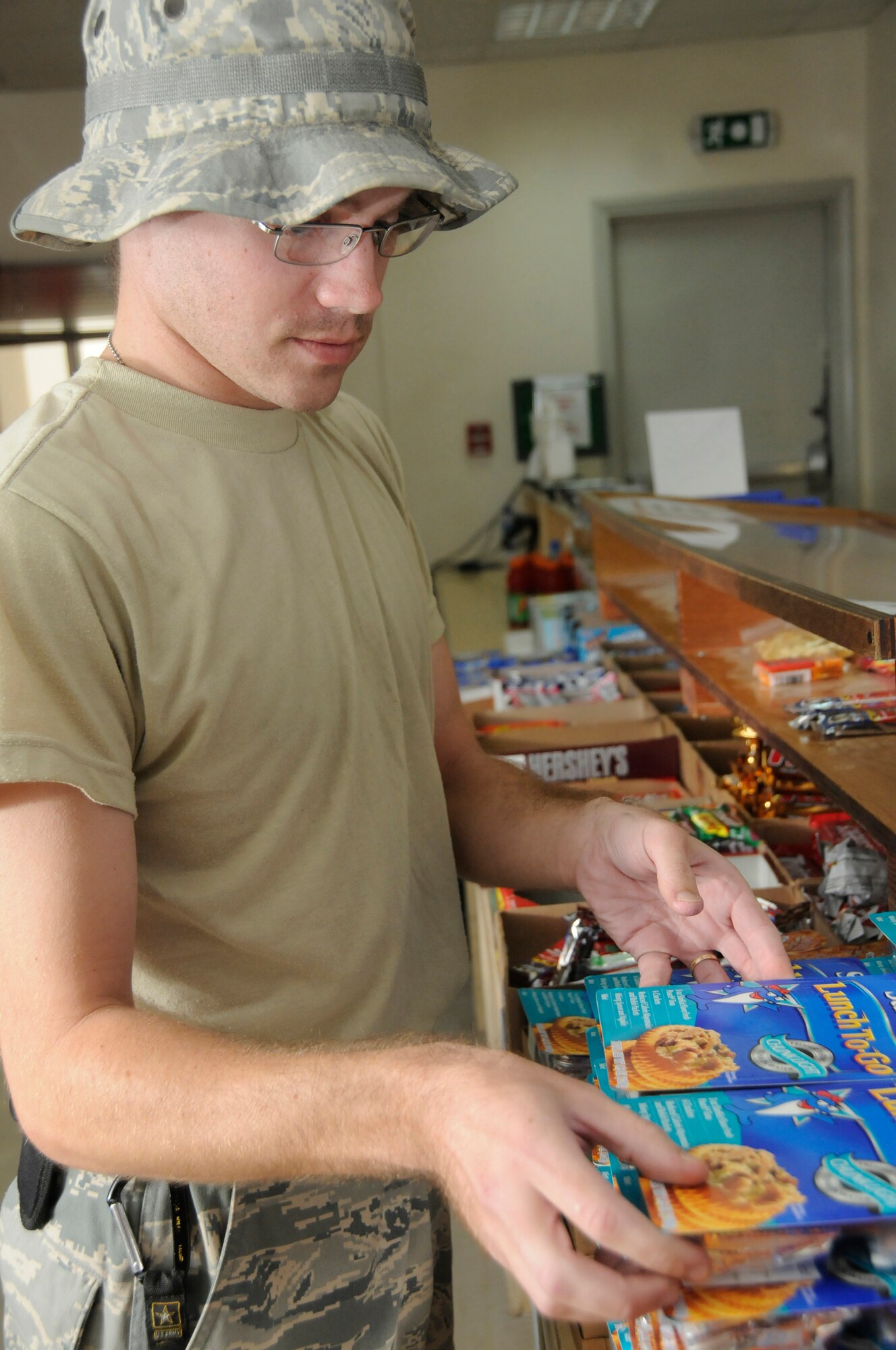 Senior Airman James Allen, shift leader assigned to the 379th Expeditionary Force Support Squadron, restocks food items at the front counter of the Grab 'n Go flight kitchen Nov. 14, at an undisclosed air base in Southwest Asia.  Airman Allen, a native of Richmond, Maine, is deployed from Dover Air Force Base, Del., in support of Operations Iraqi and Enduring Freedom and Joint Task Force-Horn of Africa. (U.S. Air Force photo by Staff Sgt. Darnell T. Cannady/Released)