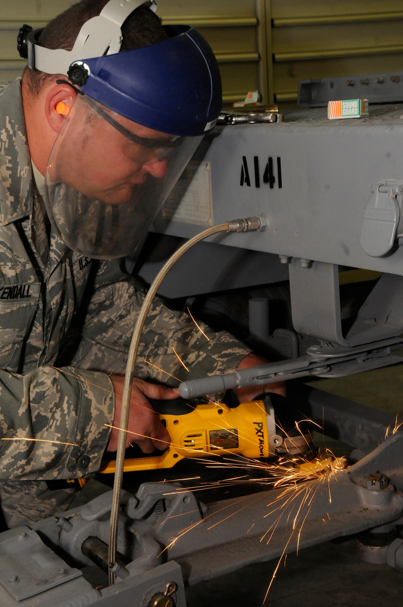 Staff Sgt. Brian Kuykendall, munitions systems journeyman assigned to the 379th Expeditionary Maintenance Squadron, uses a cut-off tool to remove a castle nut from the tie-rod of a munitions trailer Nov. 14, at an undisclosed air base in Southwest Asia. The 379th EMXS munitions section delivers weapons to the flight line to be used in the Global War on Terrorism.  Sergeant Kuykendall, a native of Reedley, Calif., is deployed from Ellsworth Air Force Base, S.D., in support of Operations Iraqi and Enduring Freedom and Joint Task Force-Horn of Africa. (U.S. Air Force photo by Staff Sgt. Darnell T. Cannady/Released)