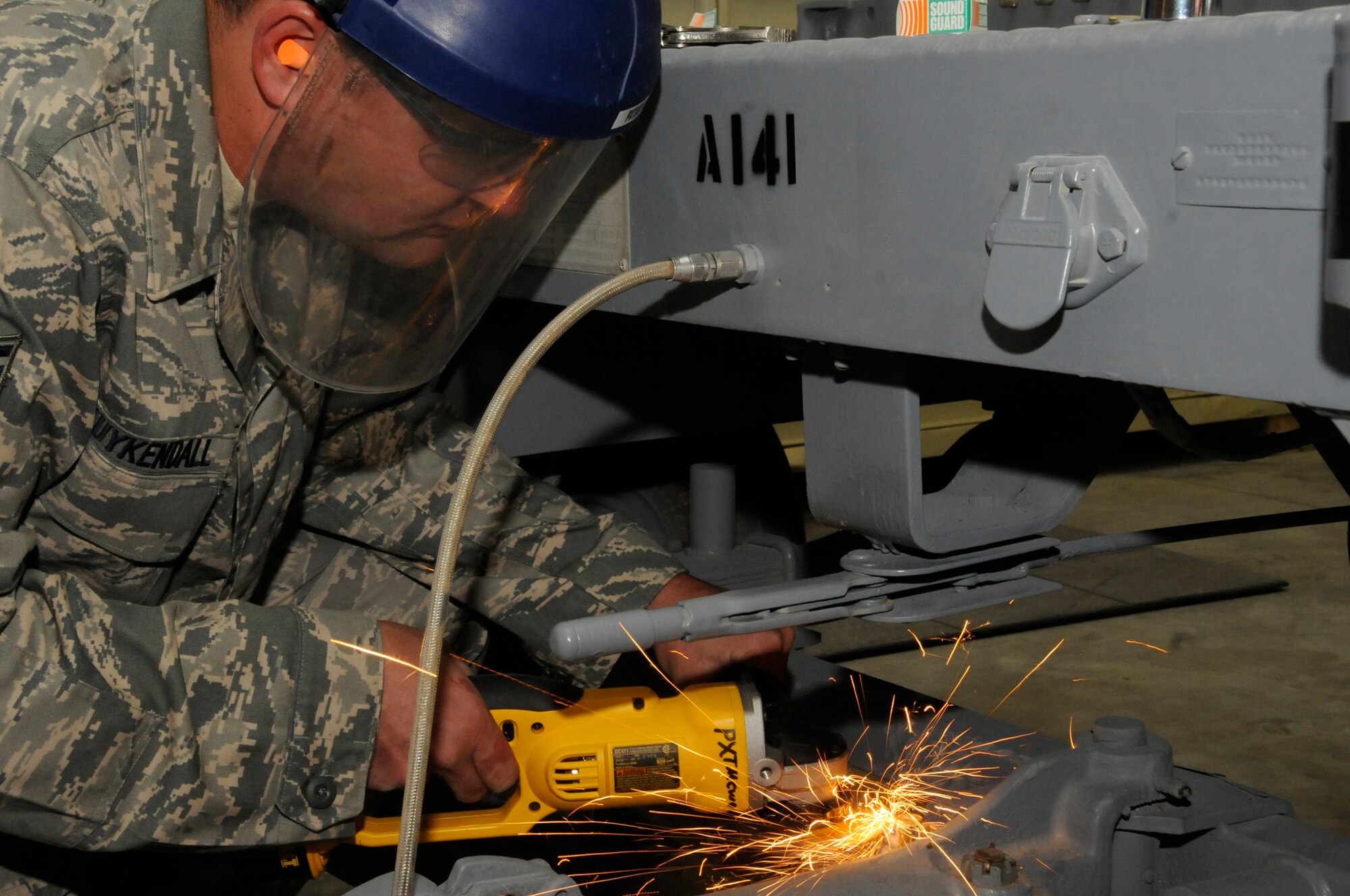 Staff Sgt. Brian Kuykendall, munitions systems journeyman assigned to the 379th Expeditionary Maintenance Squadron, uses a cut-off tool to remove a castle nut from the tie-rod of a munitions trailer Nov. 14, at an undisclosed air base in Southwest Asia. The 379th EMXS munitions section delivers weapons to the flight line to be used in the Global War on Terrorism.  Sergeant Kuykendall, a native of Reedley, Calif., is deployed from Ellsworth Air Force Base, S.D., in support of Operations Iraqi and Enduring Freedom and Joint Task Force-Horn of Africa. (U.S. Air Force photo by Staff Sgt. Darnell T. Cannady/Released)
