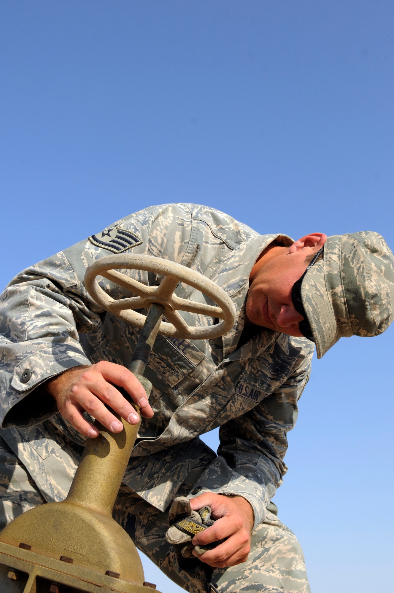 Staff Sgt. George Mitchell, fuels craftsman assigned to the 379th Expeditionary Logistics Readiness Squadron, confirms that following tightening a valve no fuel is leaking, during a regularly scheduled security and leak check of the fuel pipeline from bulk storage to operating storage, Nov. 14, at an undisclosed air base in Southwest Asia.  "Running the line" is a preventative procedure that keeps the fuel flowing to "fuel the fight."  Approximately one million gallons of fuel are moved each day through the 379 ELRS fuels section, keeping aircraft flying in Operations Iraqi and Enduring Freedom and Joint Task Force-Horn of Africa.  Sergeant Mitchell, a native of Lady Lake, Fla., is deployed from Shaw Air Force Base, S.C.  (U.S. Air Force Base photo by Tech. Sgt. Michael Boquette/Released)