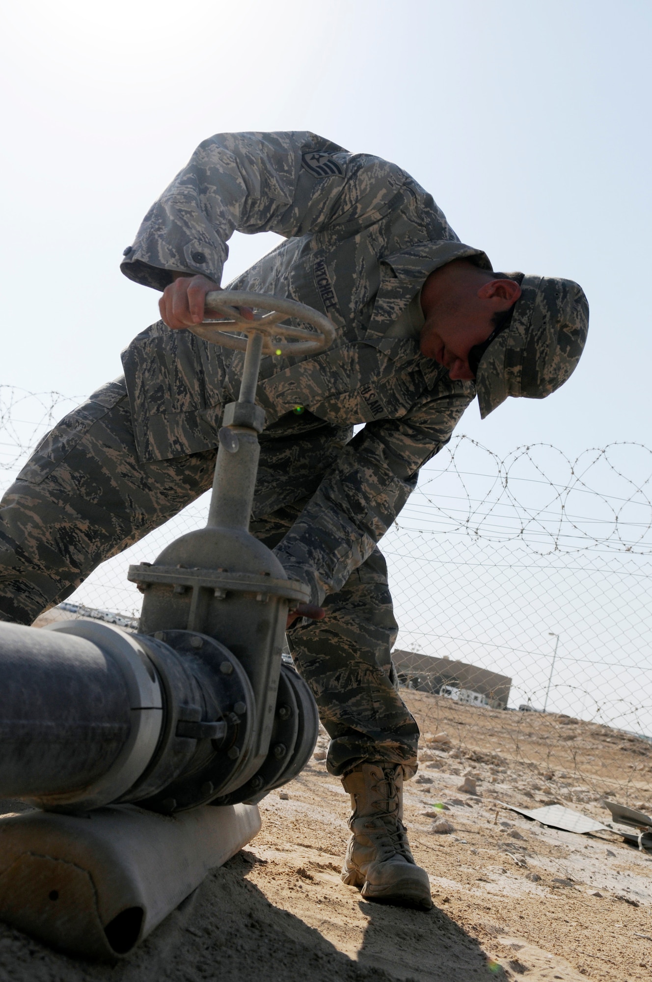 Staff Sgt. George Mitchell, fuels craftsman assigned to the 379th Expeditionary Logistics Readiness Squadron, inspects a gate valve which had earlier developed a small leak.  The inspection is part of a security and leak check of the fuel pipeline from bulk storage to operating storage, Nov. 14, at an undisclosed air base in Southwest Asia.  "Running the line" is a preventative procedure that keeps the fuel flowing to "fuel the fight."  Approximately one million gallons of fuel are moved each day through the 379 ELRS fuels section, keeping aircraft flying in Operations Iraqi and Enduring Freedom and Joint Task Force-Horn of Africa.  Sergeant Mitchell, a native of Lady Lake, Fla., is deployed from Shaw Air Force Base, S.C.  (U.S. Air Force Base photo by Tech. Sgt. Michael Boquette/Released)