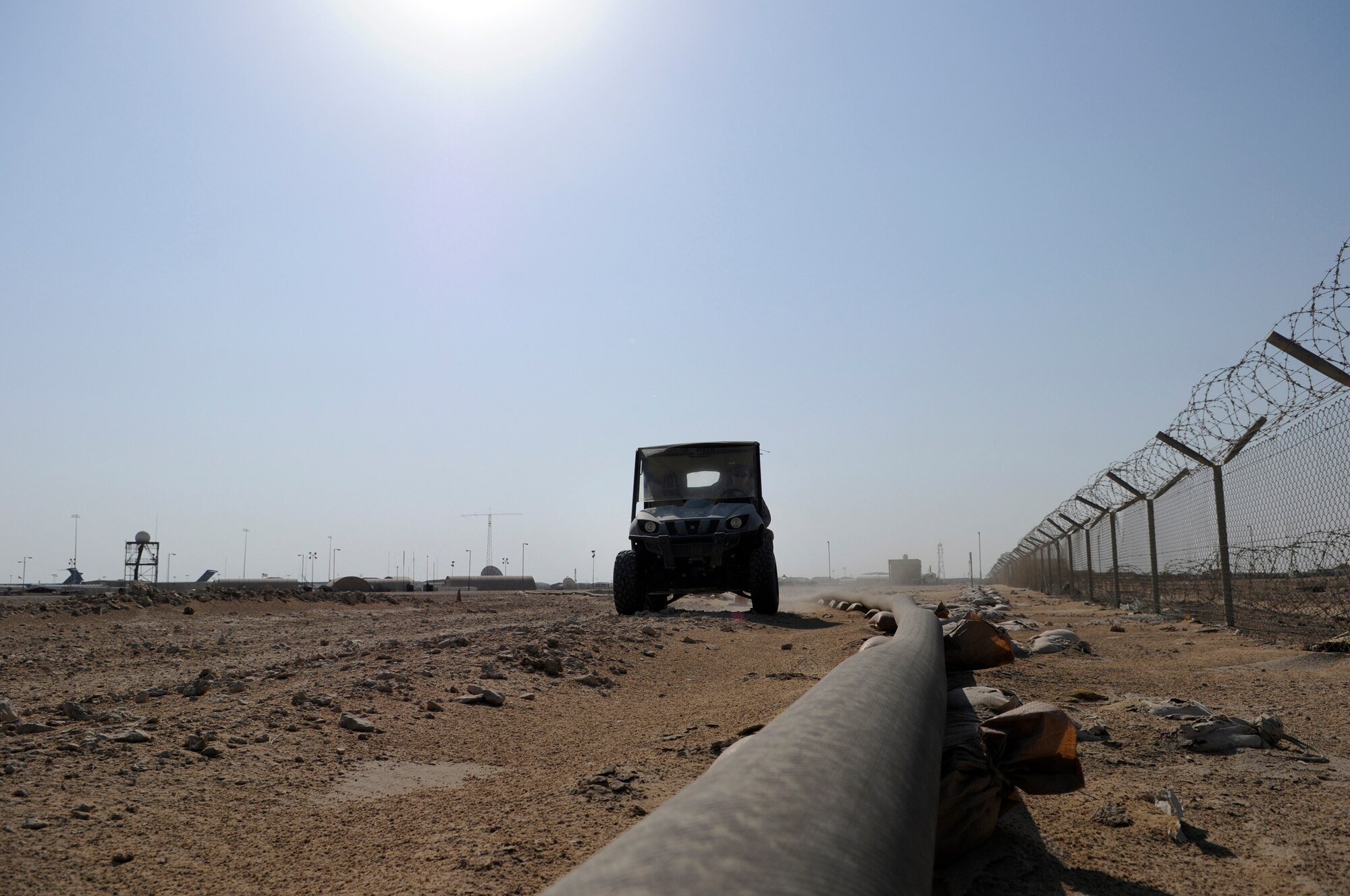 Staff Sgt. George Mitchell, fuels craftsman assigned to the 379th Expeditionary Logistics Readiness Squadron, performs a security and leak check of the fuel pipeline from bulk storage to operating storage, Nov. 14, at an undisclosed air base in Southwest Asia.  "Running the line" is a preventative procedure that keeps the fuel flowing to "fuel the fight."  Approximately one million gallons of fuel are moved each day through the 379 ELRS fuels section, keeping aircraft flying in Operations Iraqi and Enduring Freedom and Joint Task Force-Horn of Africa.  Sergeant Mitchell, a native of Lady Lake, Fla., is deployed from Shaw Air Force Base, S.C.  (U.S. Air Force Base photo by Tech. Sgt. Michael Boquette/Released)