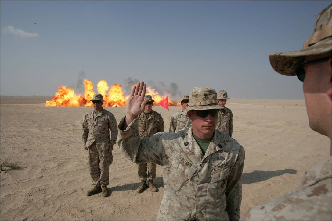 Explosive ordnance disposal technicians mark the occasion of  Staff Sgt Donavin G. Bender's reenlistment with a resounding boom. Bender, an EOD tech with Combat Logistics Battalion-26, the Logistics Combat Element for the 26th Marine Expeditionary Unit, takes the Oath of Enlistment at a training range in the Middle East, Nov. 17, 2008. Bender's reenlistment set an example for EOD's younger Marines, while giving them an opportunity to perfect their explosive ordnance skills. The EOD team spent four days clearing a training range for an upcoming exercise the MEU would conduct. They discovered and destroyed hundreds of pounds of unexploded ordnance from past exercises. After their arduous work, the Marines declared the range safe for Battalion Landing Team 2/6, the Ground Combat Element for the 26th MEU, to begin training. The 26th MEU is conducting training exercises with the host nation to strengthen cooperation with regional partners. The MEU is currently deployed aboard the ships of the Iwo Jima Strike Group in the 5th Fleet Area of Operation. (Official USMC photo by Cpl. Jason D. Mills)