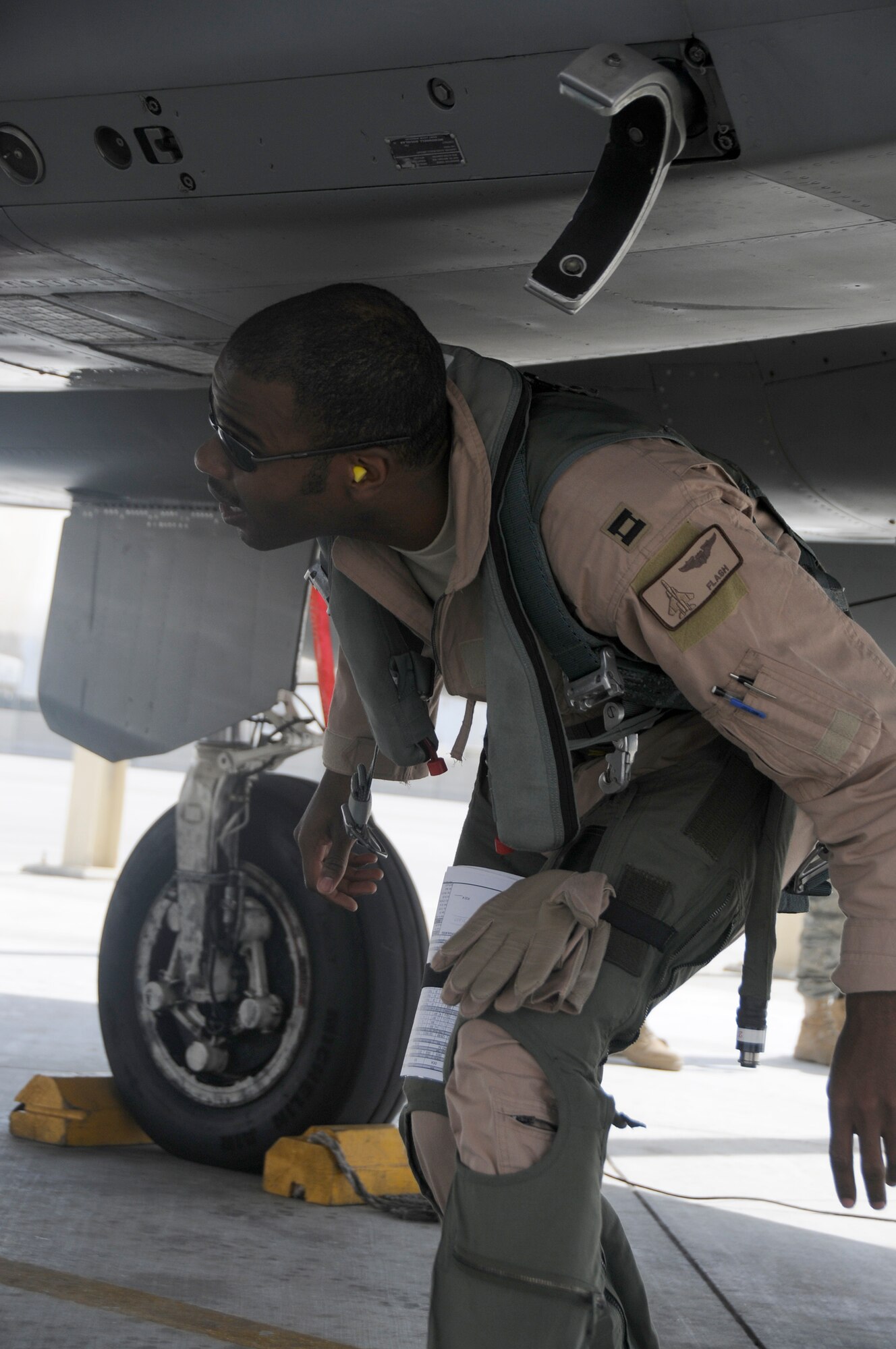 SOUTHWEST ASIA -- Capt. Rick Jones performs preflight checks of his F-15 here Nov. 13. Captain Jones is a member of the 58th Fighter Squadron, Eglin Air Force Base, Fla.. He is deployed here in support of a multi-national exercise. The exercise is to provide coalition training with various airframes with different strengths for the war on terrorism. (U.S. Air Force photo/Tech. Sgt. Christopher A. Campbell)(released)