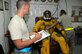 SOUTHWEST ASIA -- Senior Airman Allen Smith and Senior Airman David Sivixay test and verify Lt. Col. Brian "Bubba" Dickinson's suit here Nov. 14. Both are with the 99th Expeditionary Reconnaissance Squadron Physiological Support Division. Col. Dickinson is a U-2 Dragonlady pilot with the 99th and is responsible for gathering intelligence in the area of responsibility in support of Operation Iraqi and Enduring Freedom. All three are deployed from the 9th Reconnaissance Wing out of Beale Air Force Base, Calif. Airman Sivixay is from San Diego, Calif. Airman Smith's hometown is Tampa, Fla. and Colonel Dickinson is a native of Oscoda, Mich., and Colorado Springs, Colo.(U.S. Air Force photo/Tech. Sgt. Christopher A. Campbell)(released)