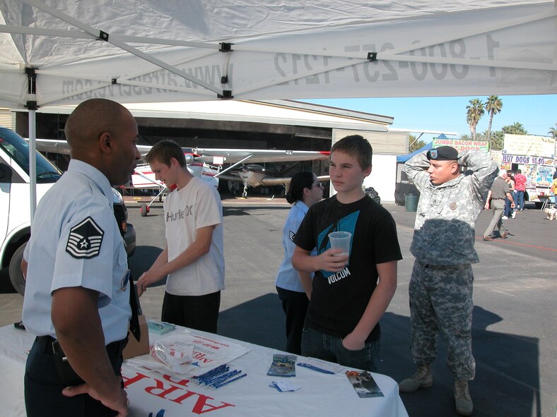 MSgt Ken Palmer, 4 AF recruiting, talks to a prospect. The day featured a veterans tribute and parade, bands as well as plenty of food and displays. War birds, hot air balloons and military vehicles awaited eager attendees. (U.S. Air Force photos by Maj. Don Traud)