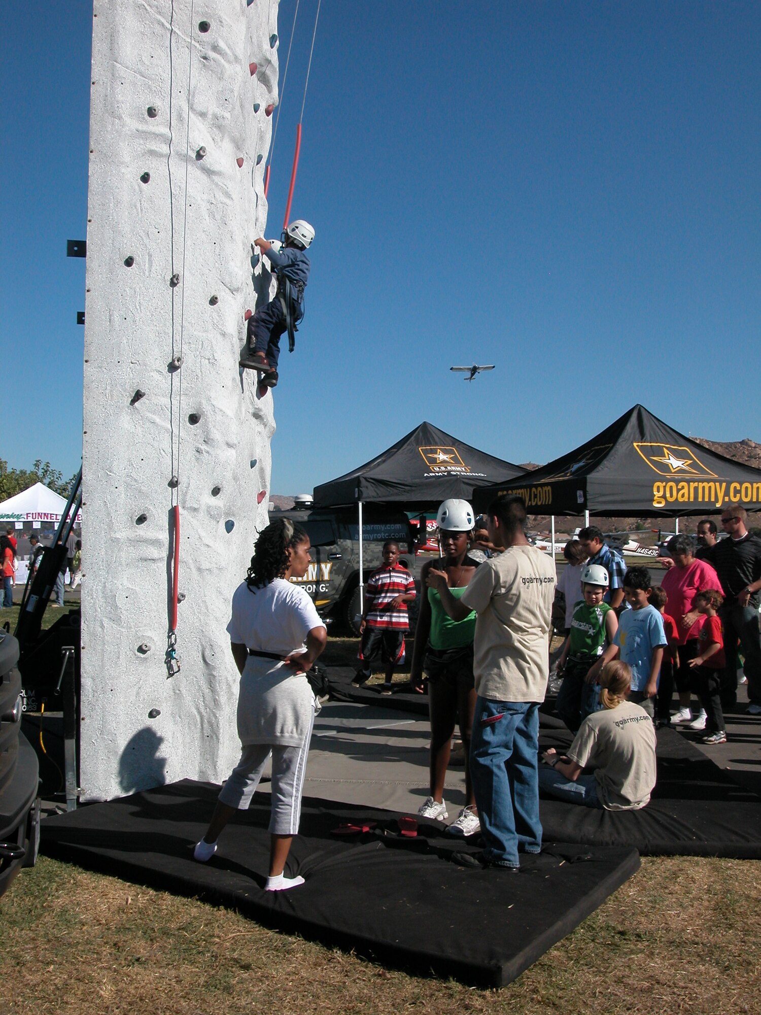 Children line up to prove they are “Army Strong” at the climbing rock during the air show on Saturday at Flabob Airport. Even though antique aircraft roused the crowd, everyone looked skyward when March’s C-17 flew by. Member from March’s 358th Civil Affairs Brigade displayed their vehicles along the runway. (U.S. Air Force photos by Maj. Don Traud)