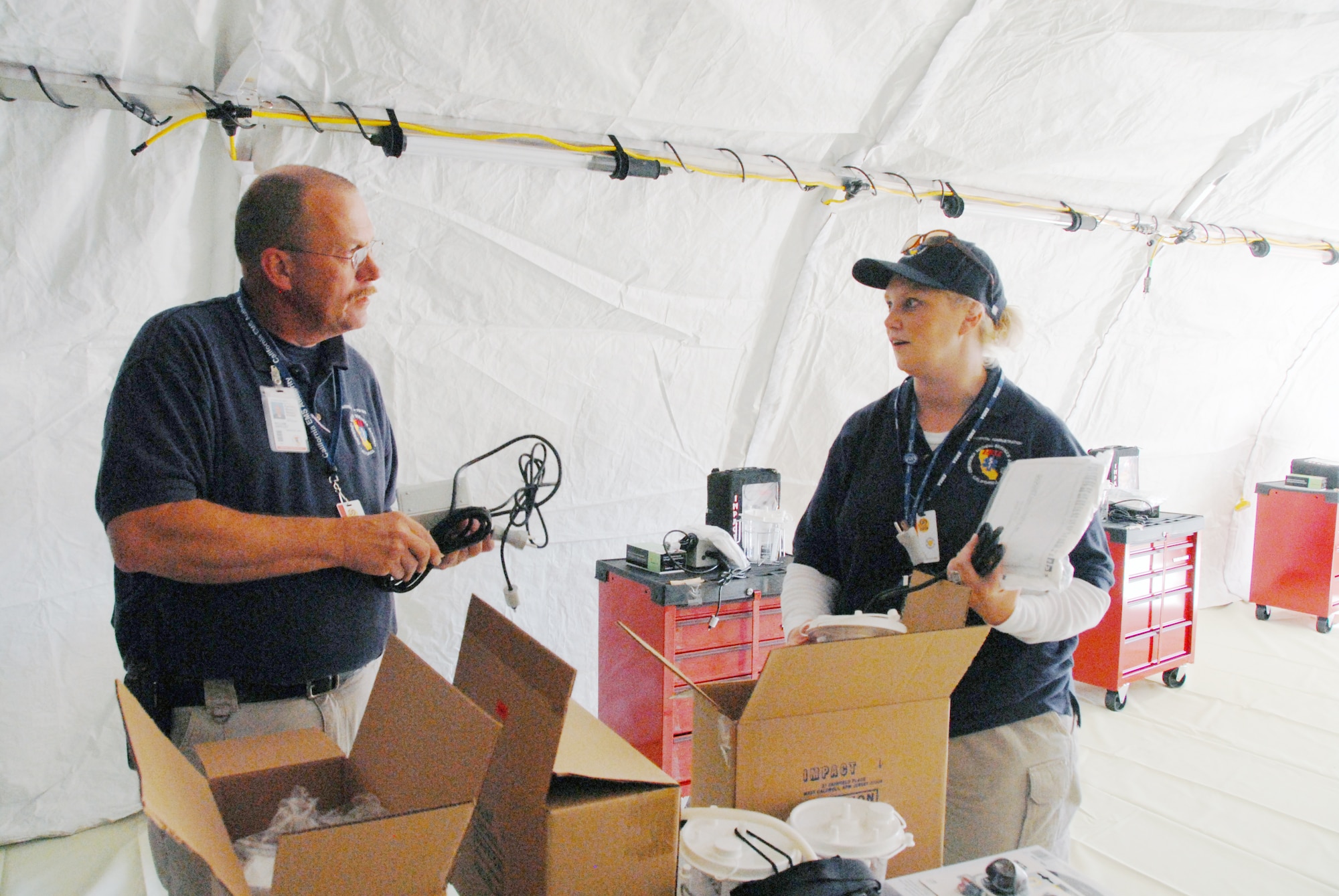 Bill Hartley and Monica Norris set up for the EMSA Field Training Event at the Regional Training Site at March ARB. (U.S. Air Force photo by Staff Sgt. Diane Ducat)