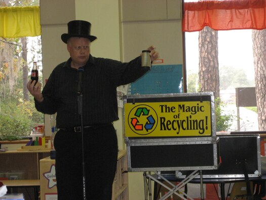 MOODY AIR FORCE BASE, Ga. -- A representative from Keep Lowndes/Valdosta Beautiful performs a magic trick during the "Magic of Recycling" show here Nov. 13. Children learned the difference between trash and recyclable goods. (Courtesy photo)